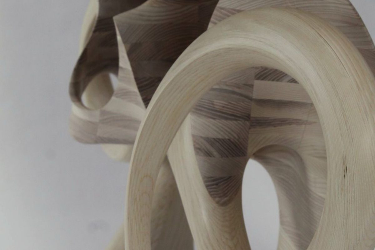 Aeolian — an ash console carried on interlocking carved loops