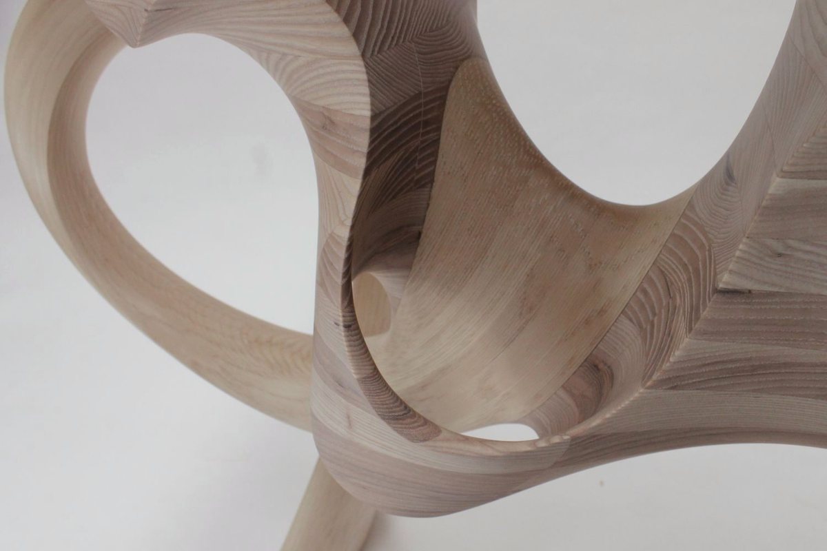 Aeolian — an ash console carried on interlocking carved loops
