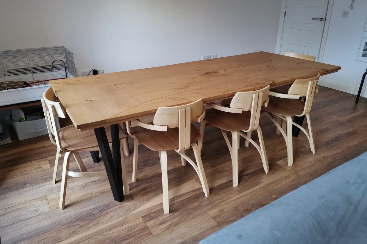 A dining table, bench and steam-bent chairs, in the room they were made for