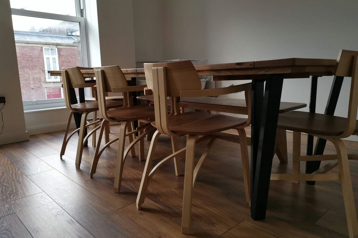 A dining table, bench and steam-bent chairs, in the room they were made for