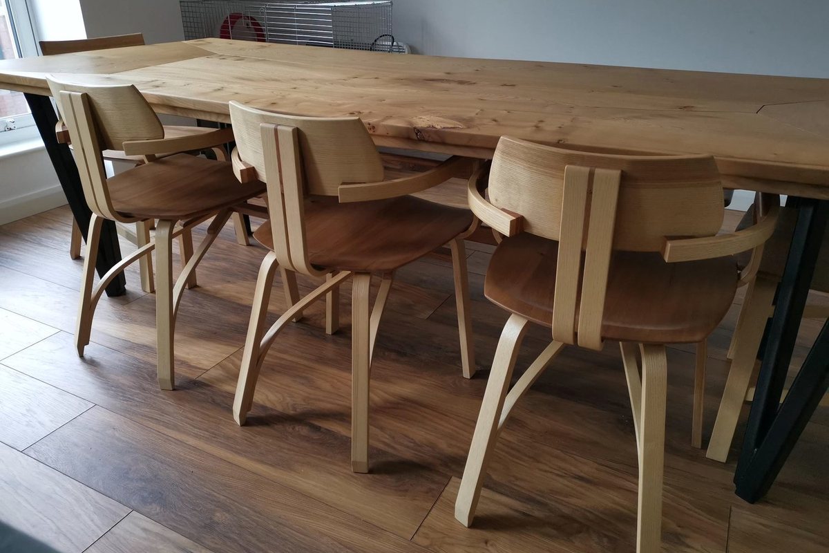 A dining table, bench and steam-bent chairs, in the room they were made for