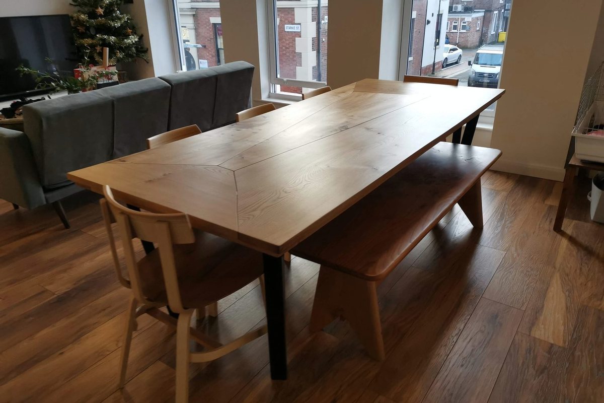 A dining table, bench and steam-bent chairs, in the room they were made for