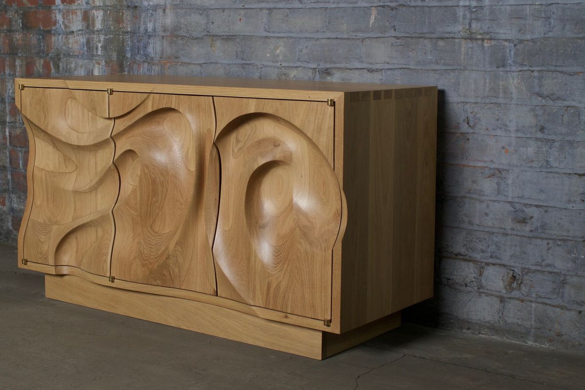 Waves — an oak cabinet carved in a deep wave relief
