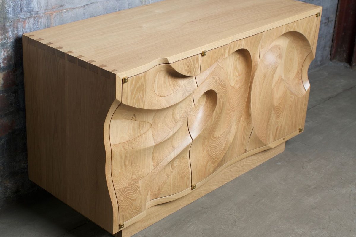 Waves — an oak cabinet carved in a deep wave relief