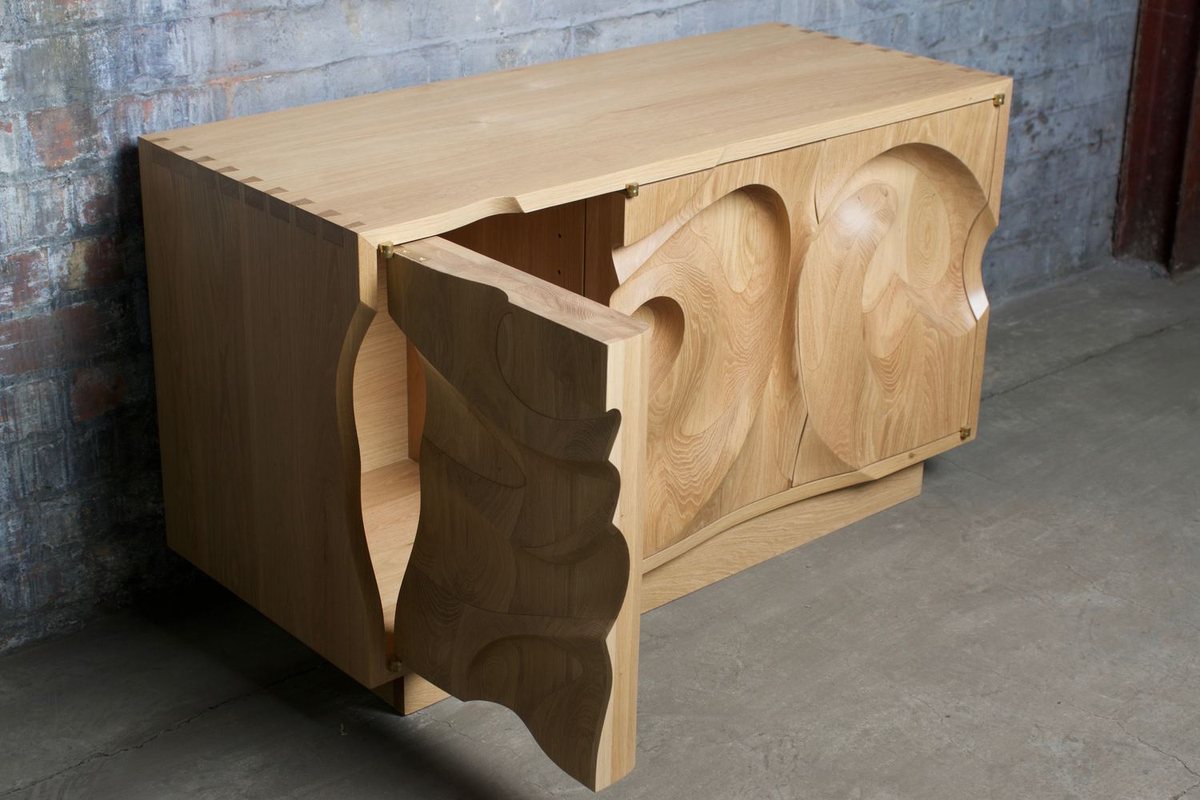 Waves — an oak cabinet carved in a deep wave relief