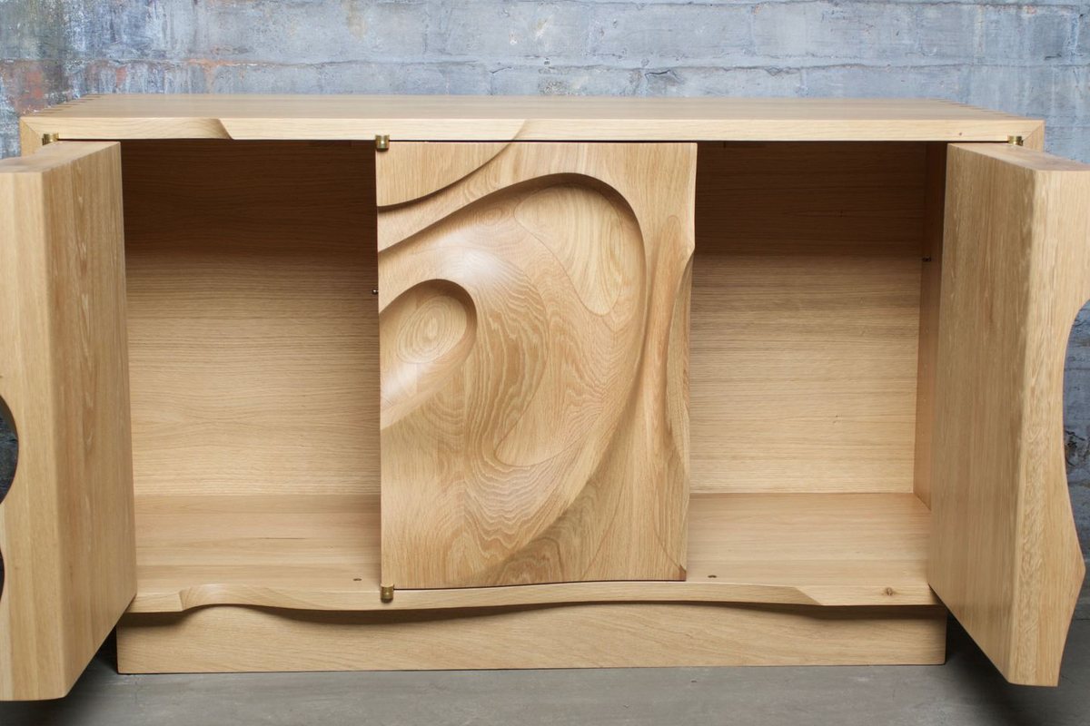 Waves — an oak cabinet carved in a deep wave relief