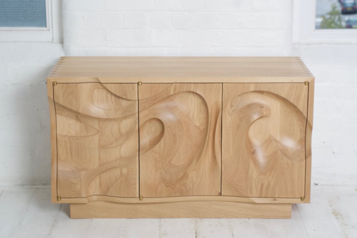 Waves — an oak cabinet carved in a deep wave relief