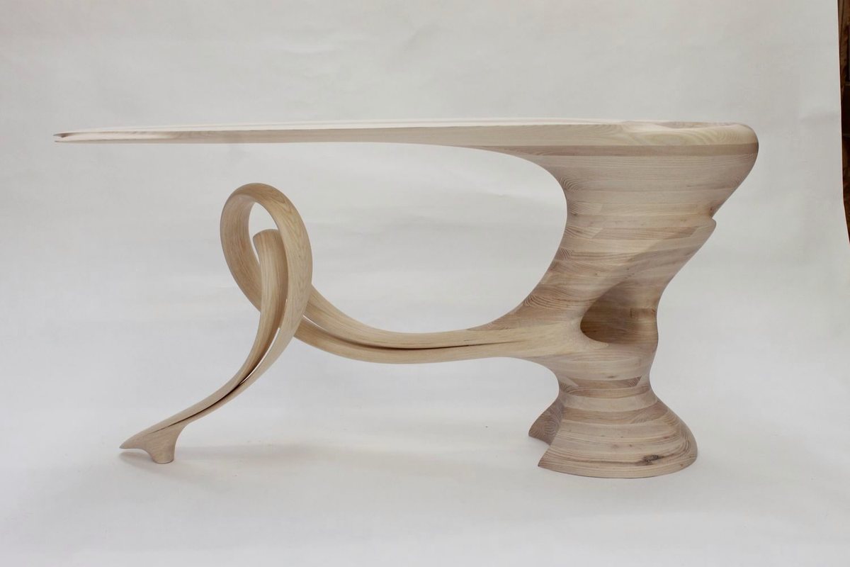 Reinga — an ash console table, its top balanced on a coiled leg