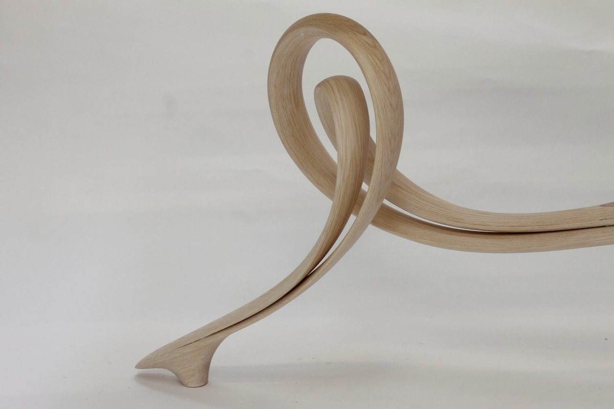 Reinga — an ash console table, its top balanced on a coiled leg