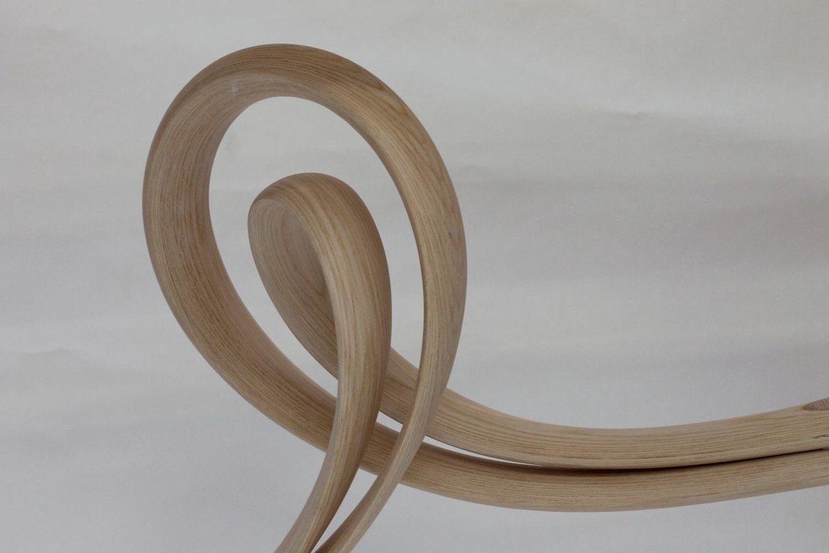 Reinga — an ash console table, its top balanced on a coiled leg