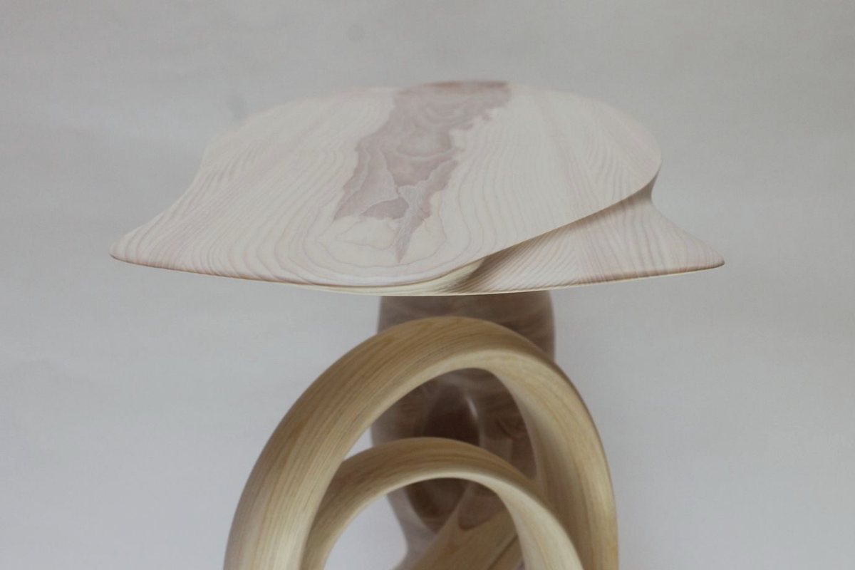 Reinga — an ash console table, its top balanced on a coiled leg