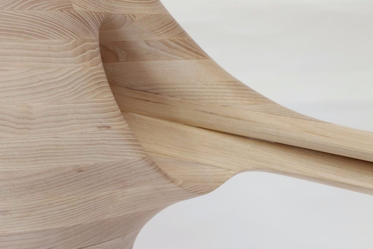 Reinga — an ash console table, its top balanced on a coiled leg