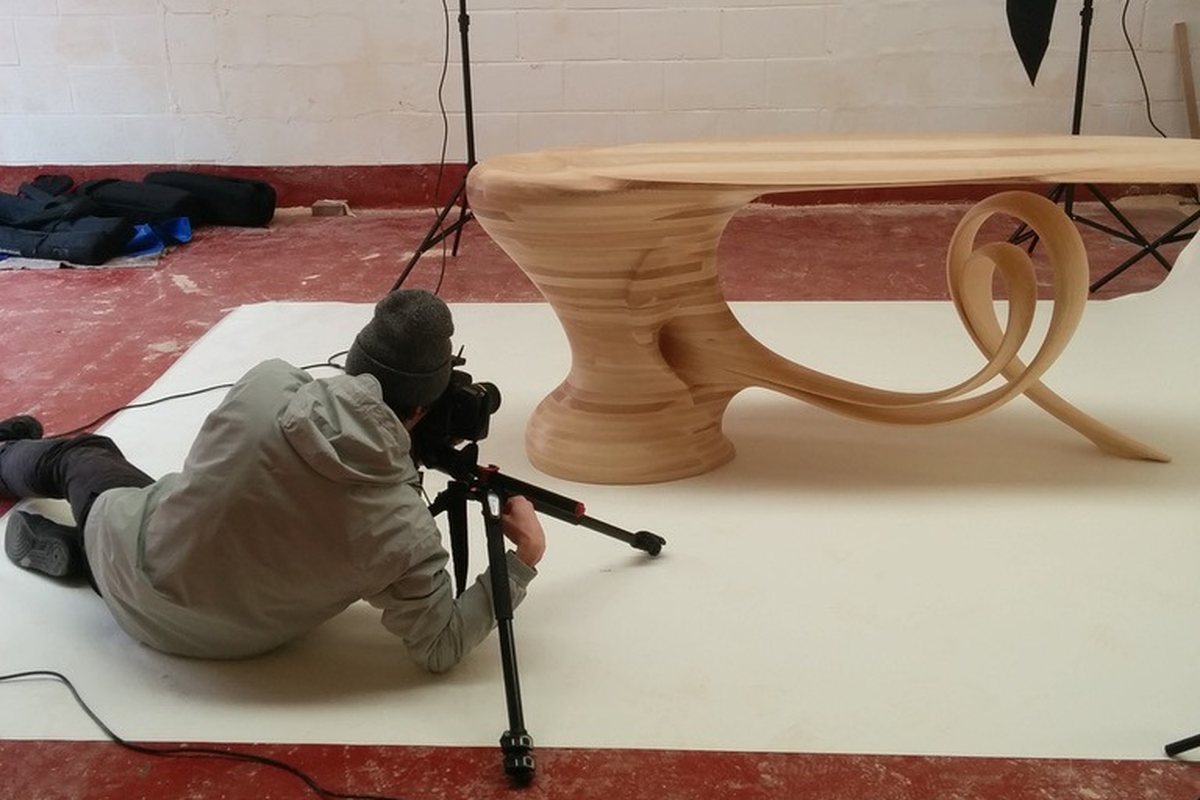 Reinga — an ash console table, its top balanced on a coiled leg
