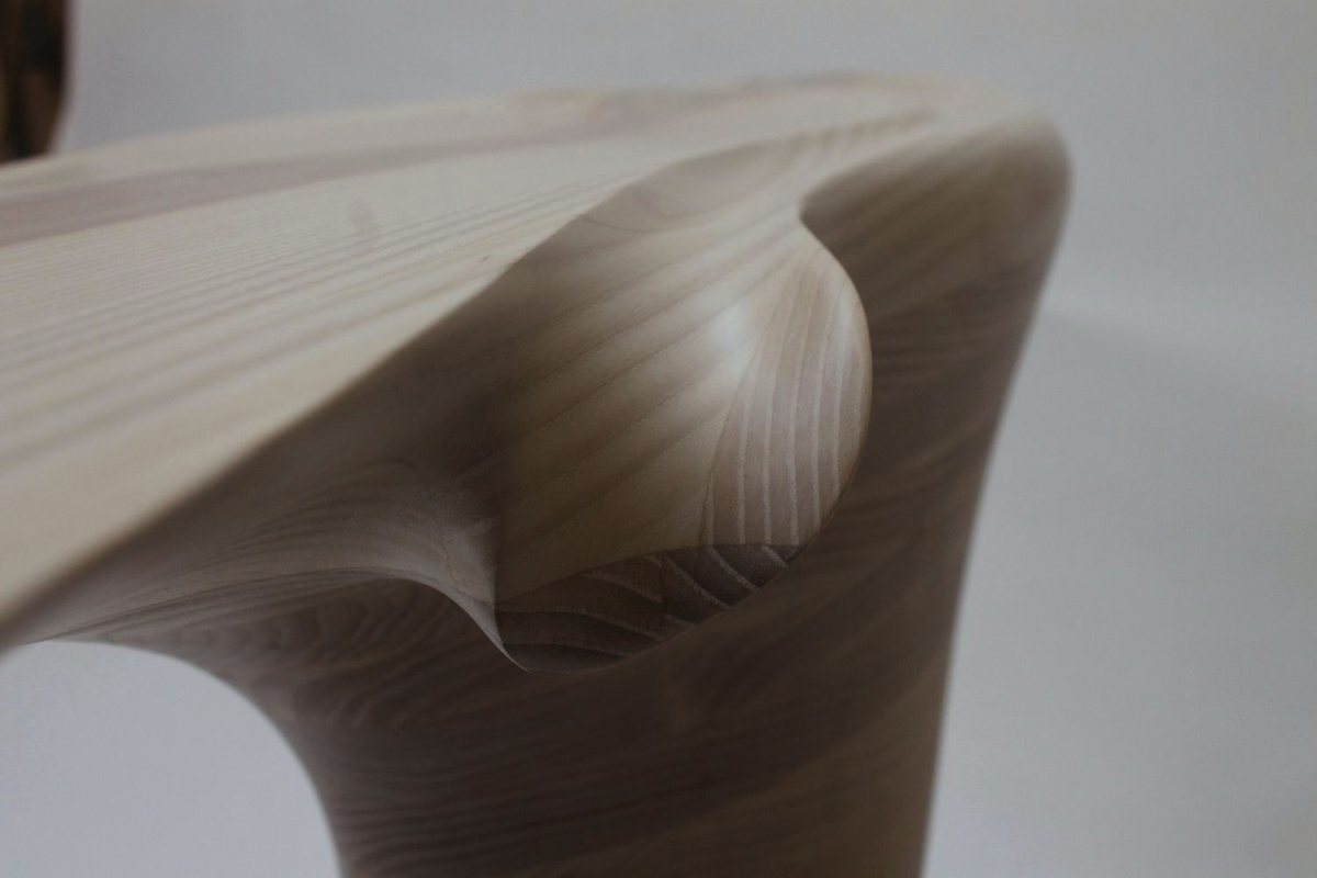 Reinga — an ash console table, its top balanced on a coiled leg