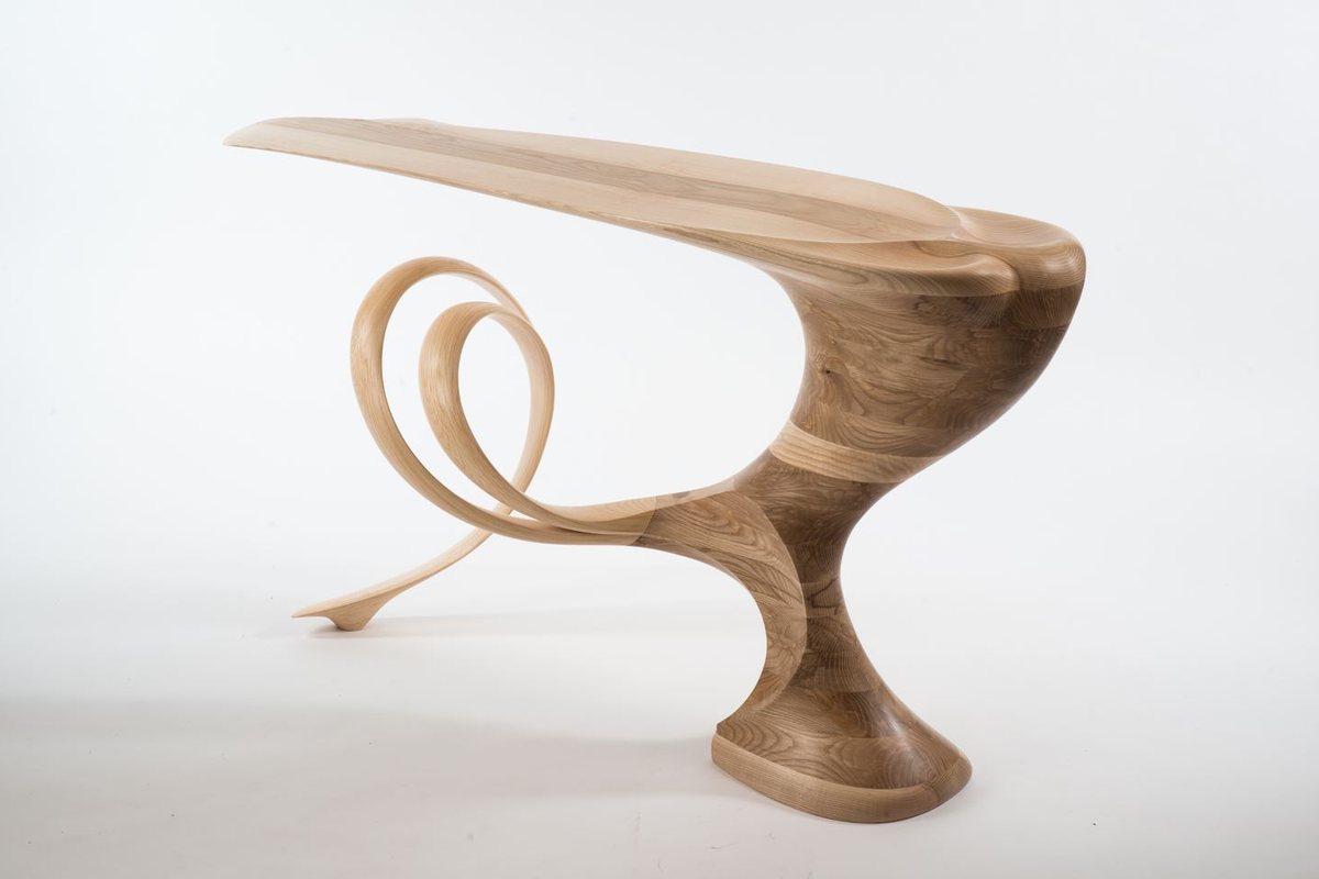 Roxanne — a console with a lobed top on a carved pedestal