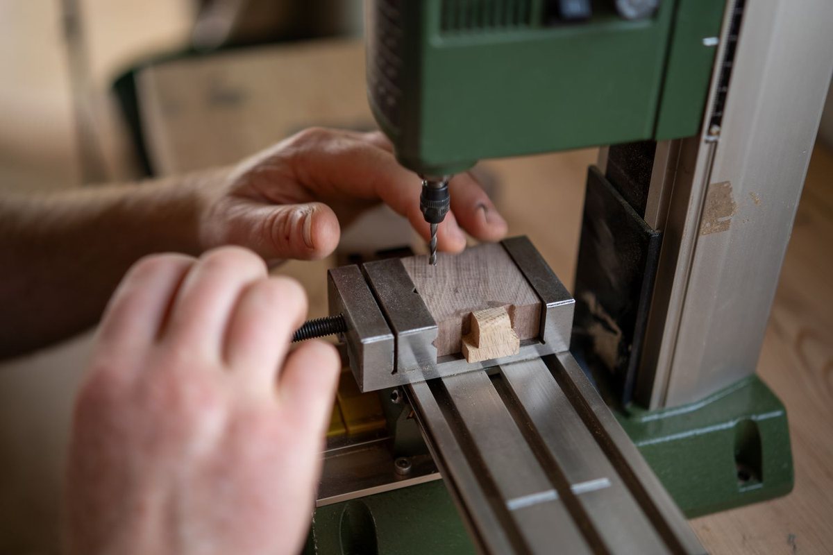 Work under way — hands, tools and timber