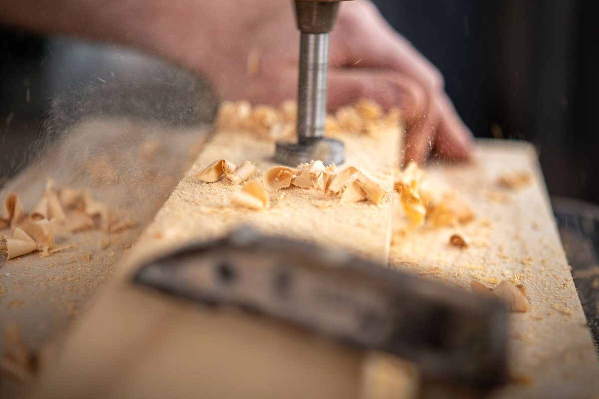 Work under way — hands, tools and timber