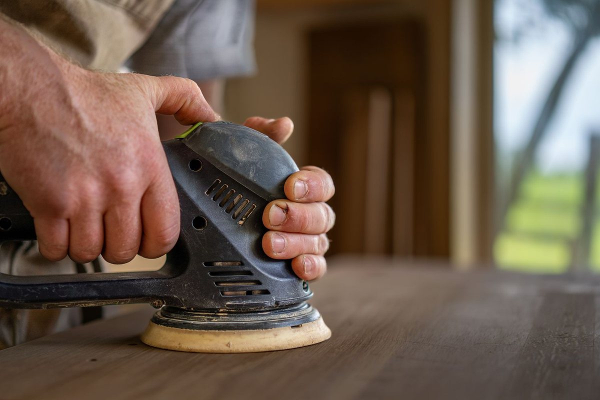 Work under way — hands, tools and timber