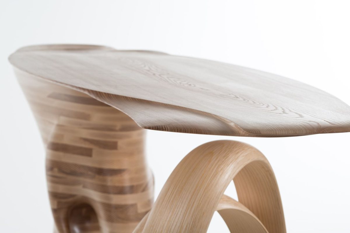 Waiho — a console table in ash, its top carried above a curling ribbon leg