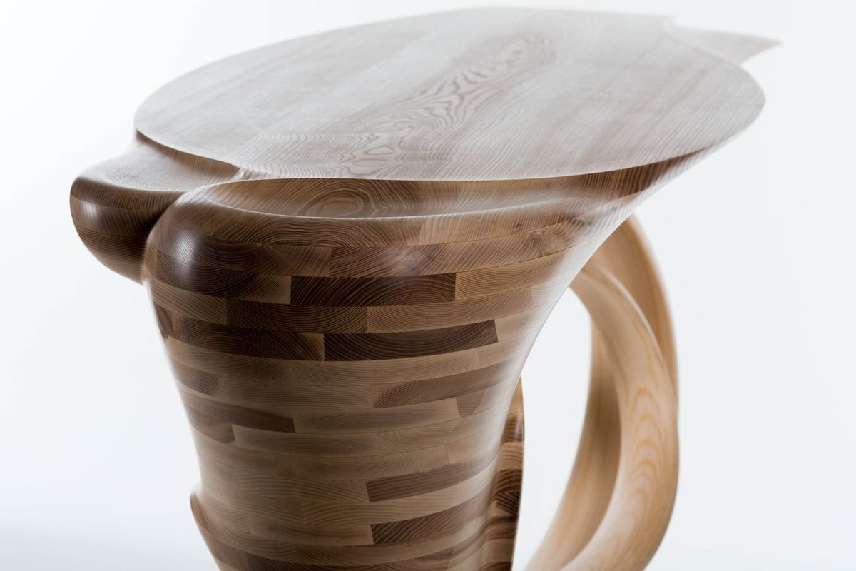 Waiho — a console table in ash, its top carried above a curling ribbon leg