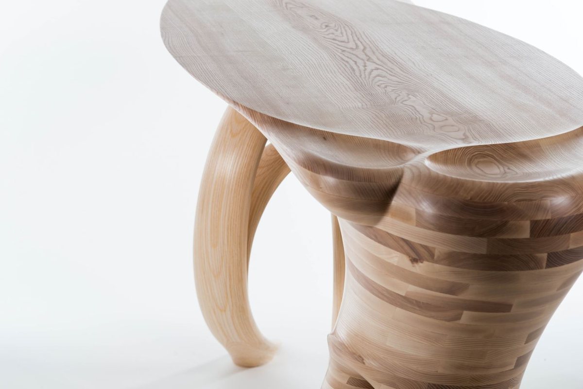 Waiho — a console table in ash, its top carried above a curling ribbon leg