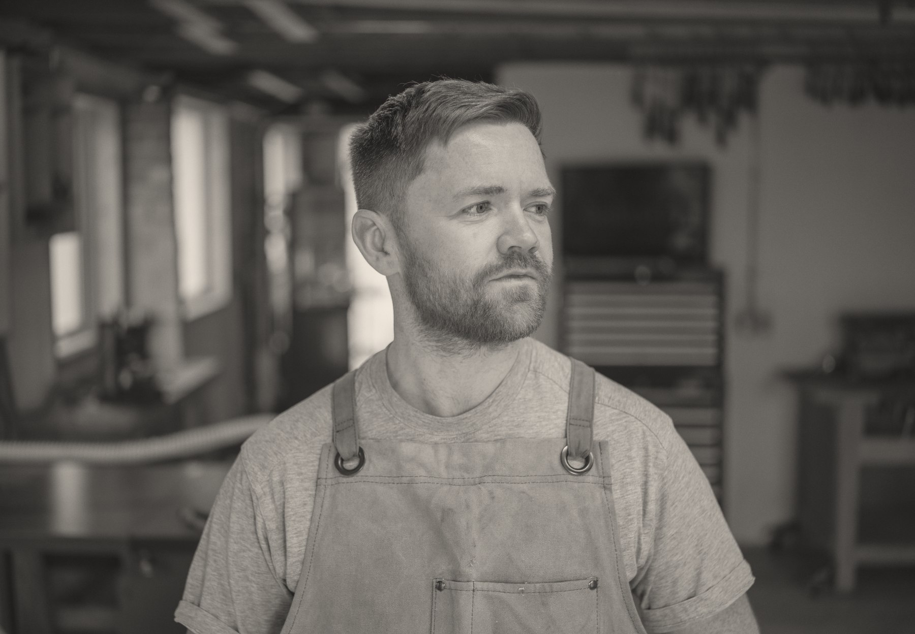 Robert Scott in the workshop, wearing his work apron.